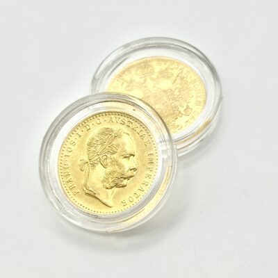 Austrian ducat from 1915 displayed in protective capsules.