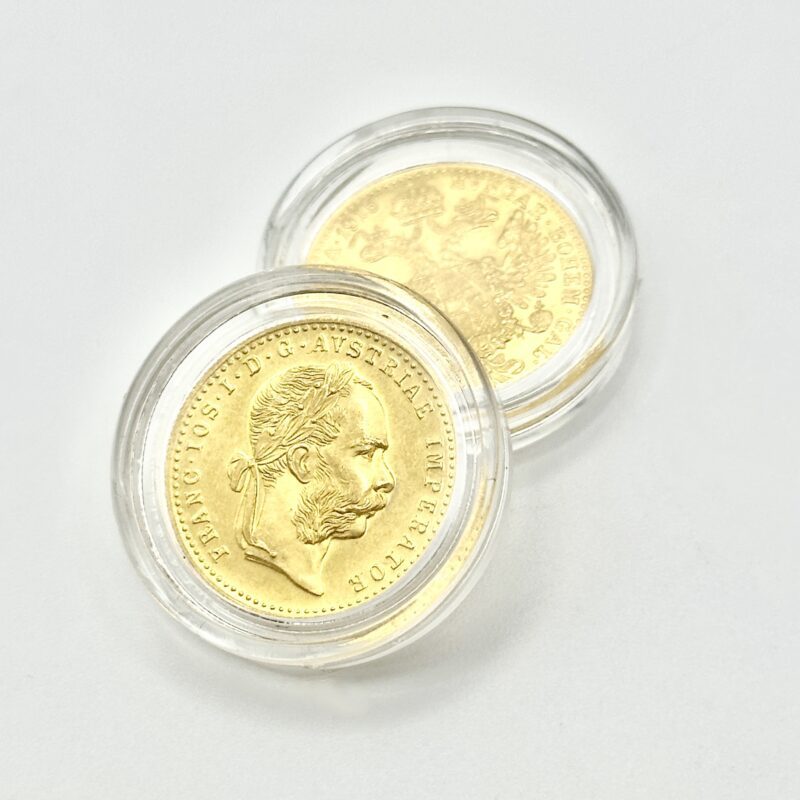 Austrian ducat from 1915 displayed in protective capsules.